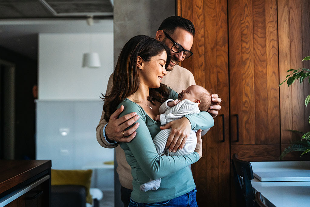Couple holding their young baby.