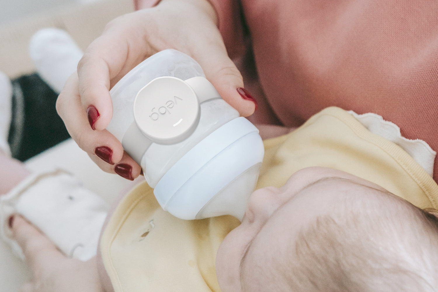 Image of Veba Baby Smart Bottle Monitor with Young Newborn Baby.